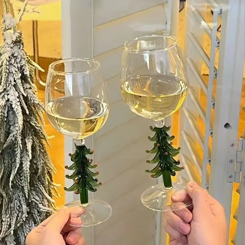 DecorBites Christmas glass goblet set with green tree-shaped stems holding white wine for festive drinkware