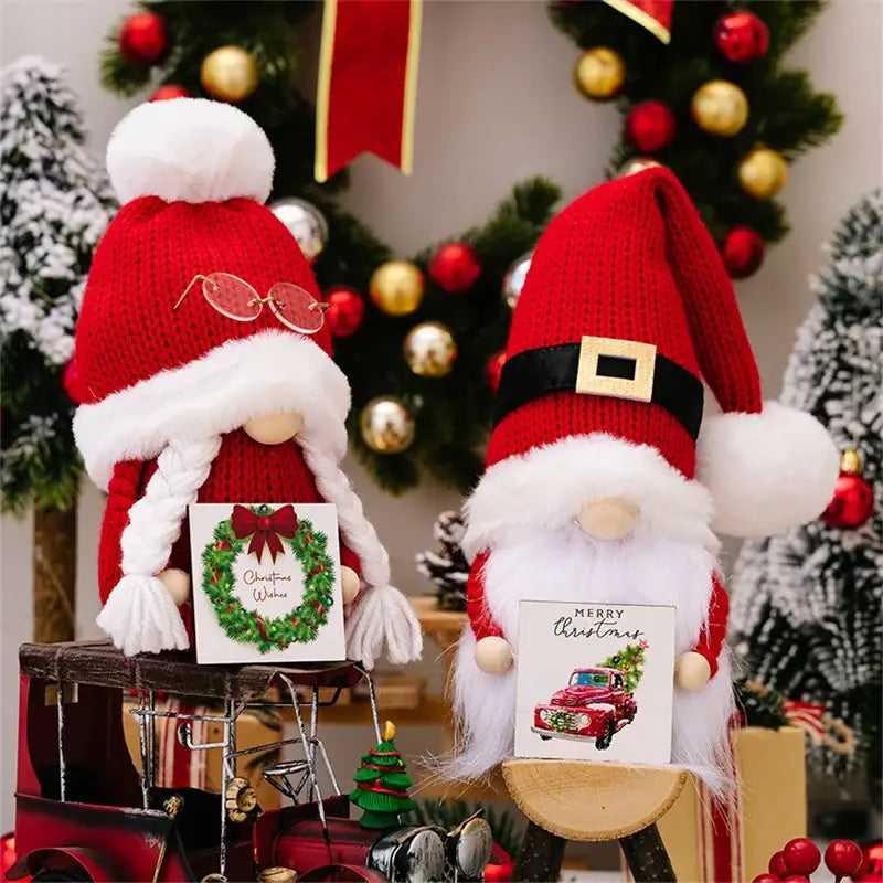 Two festive knitted christmas gnome dolls with hats holding holiday cards for xmas home decor by decorbites
