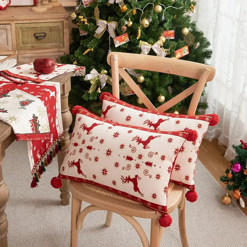 Red and cream DecorBites Christmas jacquard pillow cover with elk snowflake embroidery and pom-poms for festive decor