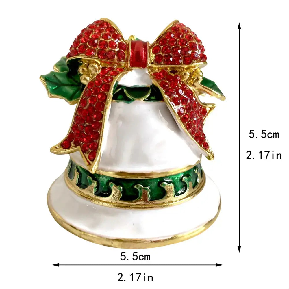 A festive white enamel christmas bell jewelry trinket box with red rhinestone bow and gold-trimmed holly leaves
