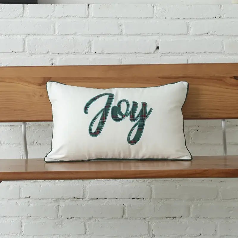 White rectangular pillow with decorbites christmas letter embroidery plaid featuring joy in green plaid script and dark piping
