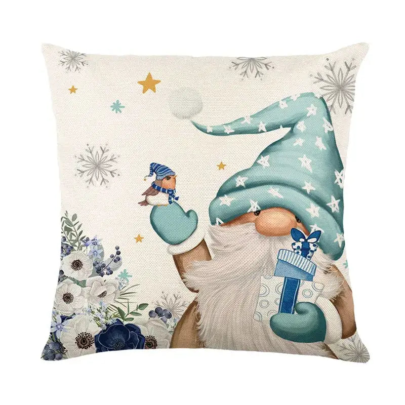Beige linen pillow cover featuring a whimsical gnome in teal hat holding a gift with snowflakes and flowers decorbites christmas letter print