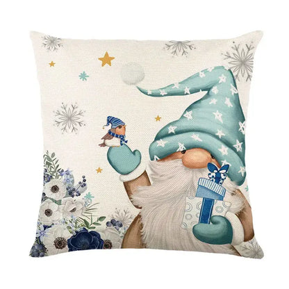 Beige linen pillow cover featuring a whimsical gnome in teal hat holding a gift with snowflakes and flowers decorbites christmas letter print