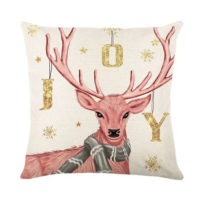 Cream-colored linen throw pillow cover with decorbites christmas letter print featuring pink deer and holiday motifs