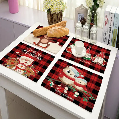 Set of four festive red and black plaid linen dining table mats with santa, reindeer, owls, and snowmen for christmas decor