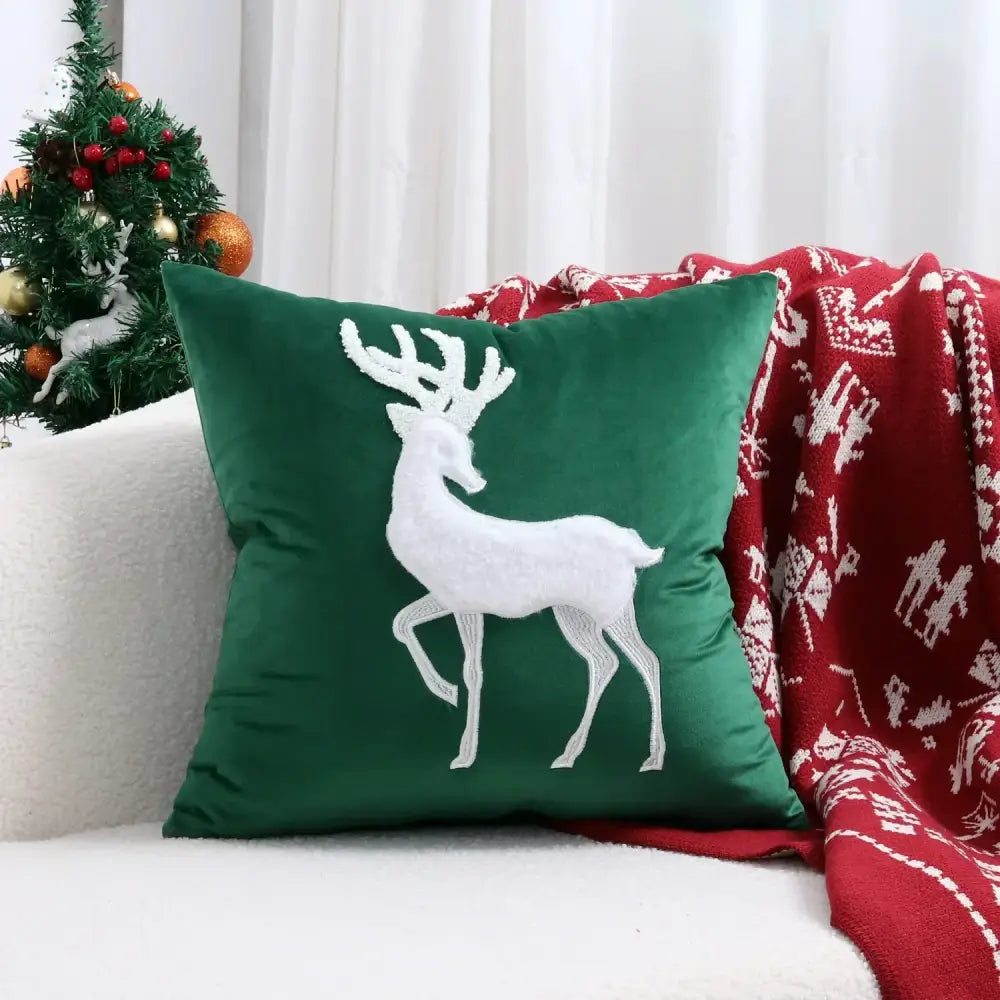 Deep green velvet cushion cover with white embroidered reindeer from decorbites christmas patchwork merrychristmas collection