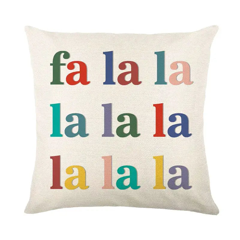 A cream-colored linen throw pillow with multicolored fa la la text from decorbites christmas pillowcase collection