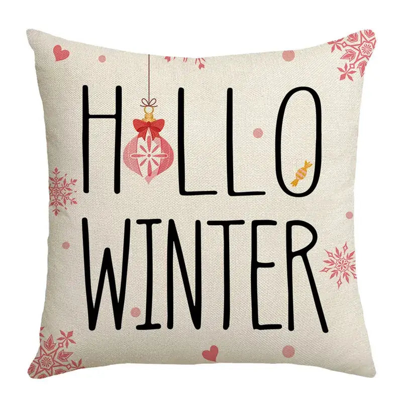 Beige linen throw pillow with hello winter black lettering pink snowflakes red ornament from decorbites christmas pillowcase collection