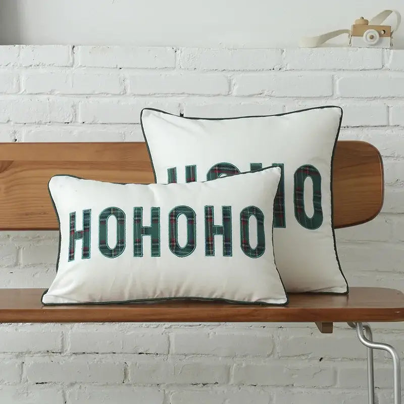 White rectangular cushion cover with hohoo in bold green plaid letters and black piping by DecorBites Christmas plaid cotton