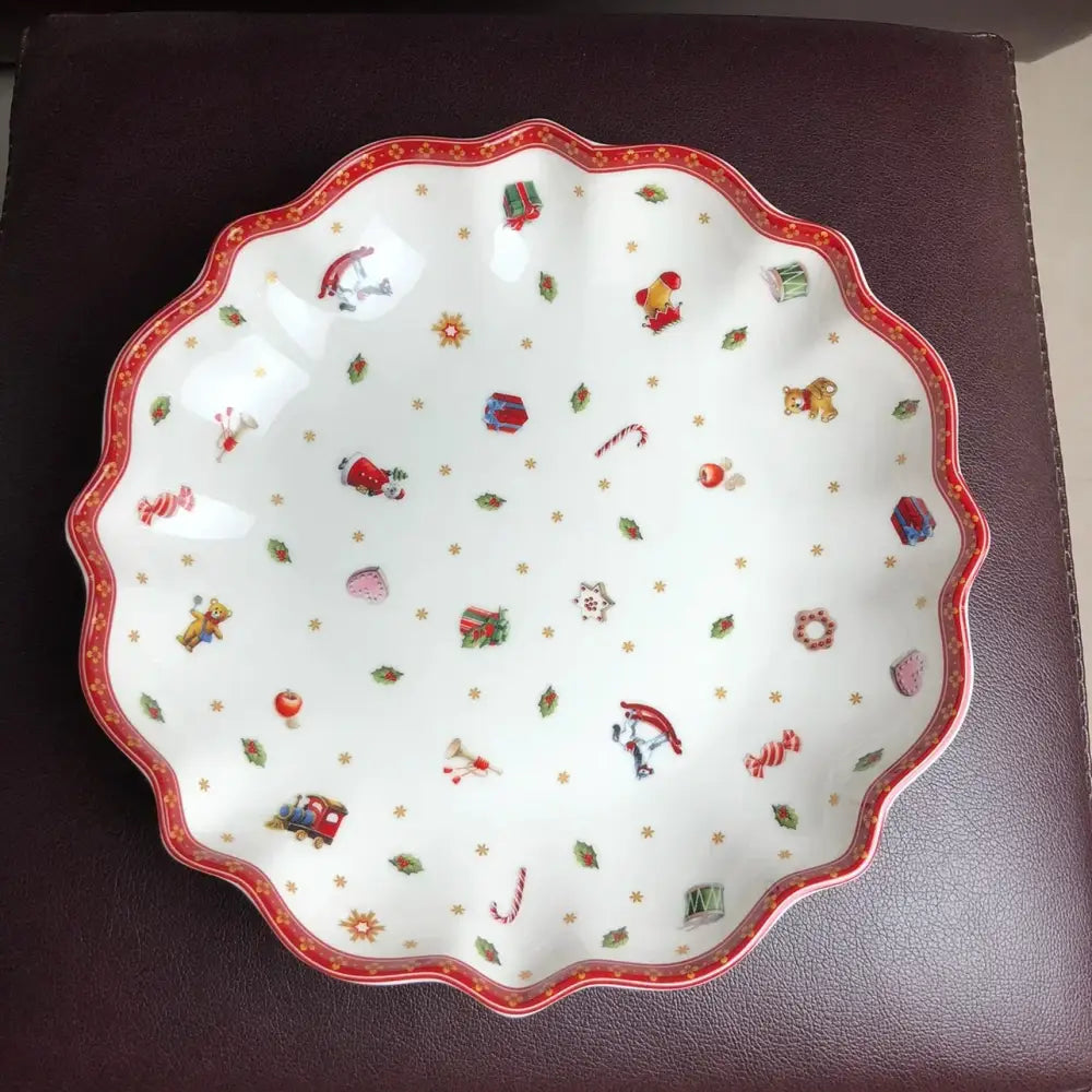 Festive white ceramic serving dish with scalloped red rim and colorful christmas illustrations from DecorBites Christmas porcelain tableware set