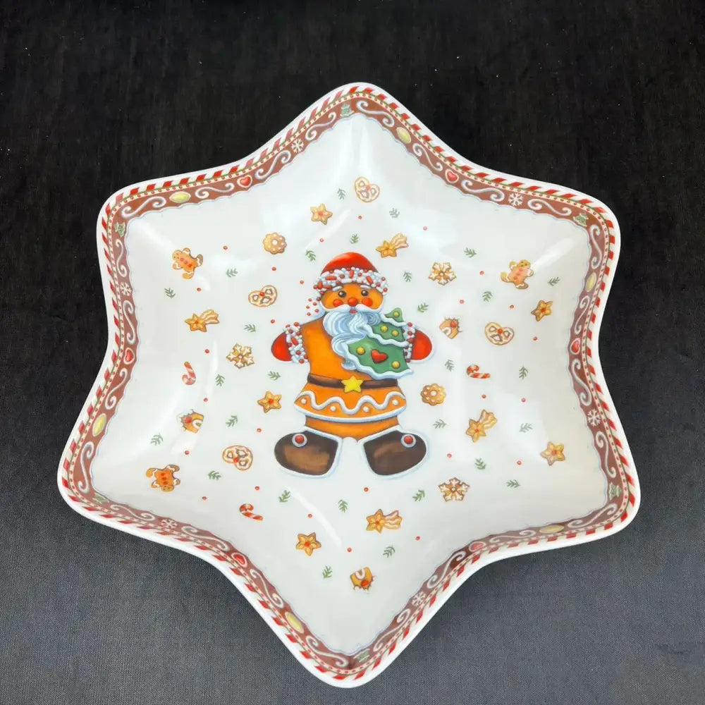 A white ceramic star-shaped dish with a gingerbread santa illustration from decorbites christmas porcelain tableware set