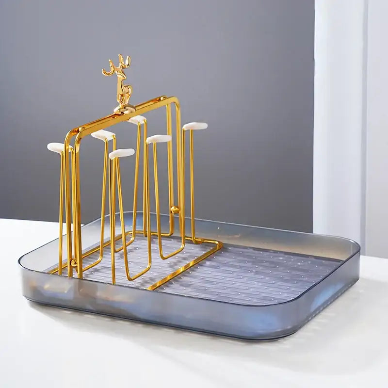 Gold metal deer-top cups holder set with white silicone grips and translucent gray plastic base for drying glasses