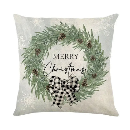 Beige pillow cover by DecorBites Christmas Snow featuring a green pine wreath with pinecones and a checkered bow