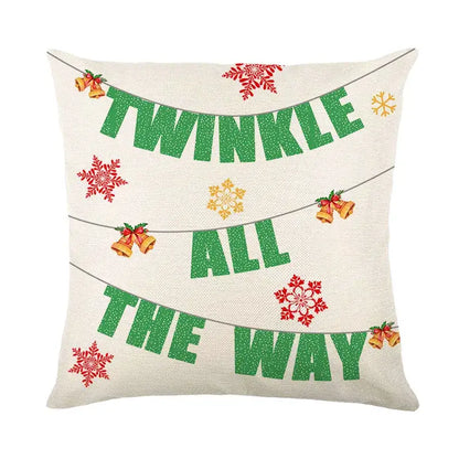Cream-colored decorbites christmas snow elk pillow cover with glittery green text red and gold snowflakes and golden bells