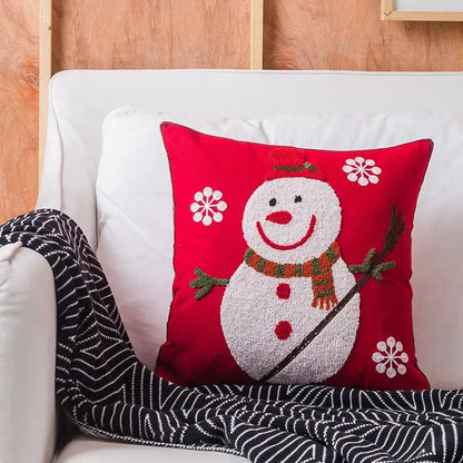 Red cushion featuring a textured white snowman with red hat and scarf surrounded by embroidered white snowflakes from decorbites christmas snowflake elk collection