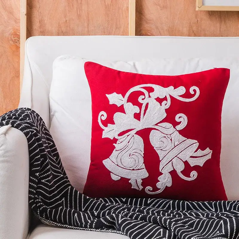 Red square pillow with white embroidered bells and holly design from decorbites christmas snowflake elk collection