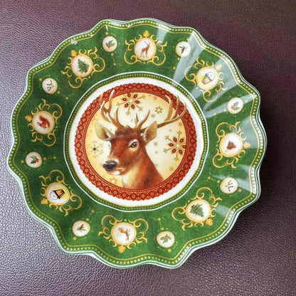 A festive green ceramic serving dish from decorbites christmas tableware featuring a deer and red snowflake patterns
