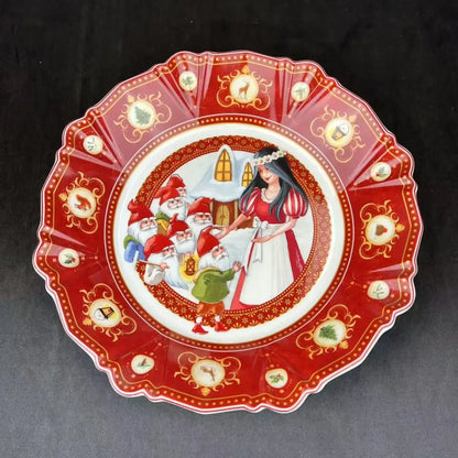 A red and gold decorative plate with snow white and the seven dwarfs illustration from decorbites christmas tableware set