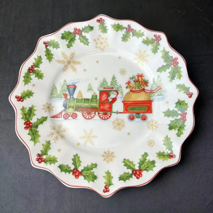 White ceramic plate with scalloped edge featuring festive christmas train design and holly from decorbites christmas tableware