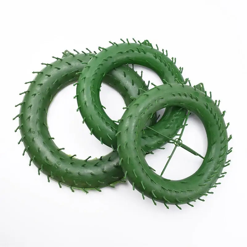 Green plastic floral wreath forms with spiked edges and wire supports for DecorBites christmas tree decor suspension