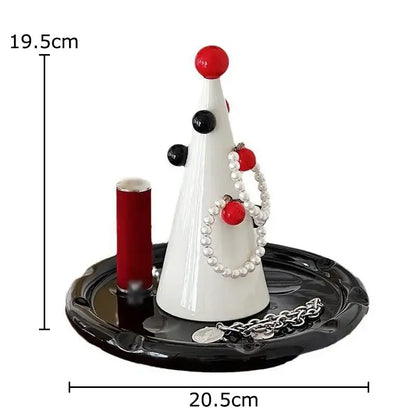 White ceramic christmas tree jewelry stand by DecorBites with red ornaments and pearl necklace on black base display