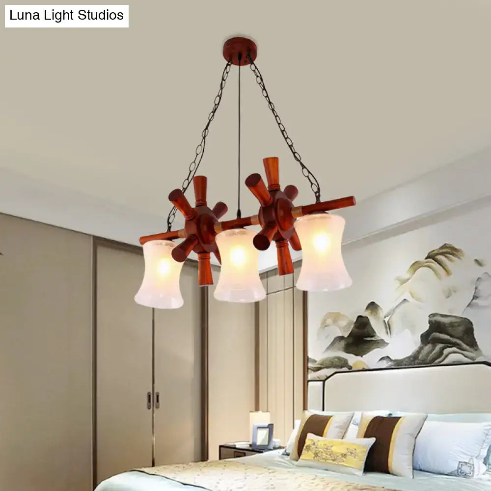 Rustic wooden pendant light kit with three cream crackle glass shades and dark metal chains for dining room island