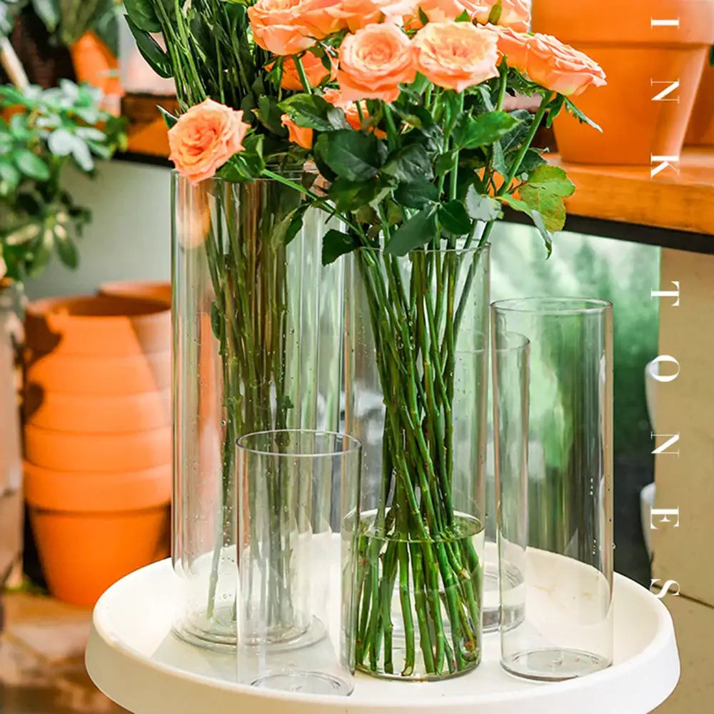 DecorBites™ large clear acrylic hurricane flower vase with peach roses in varying height clear cylindrical vases