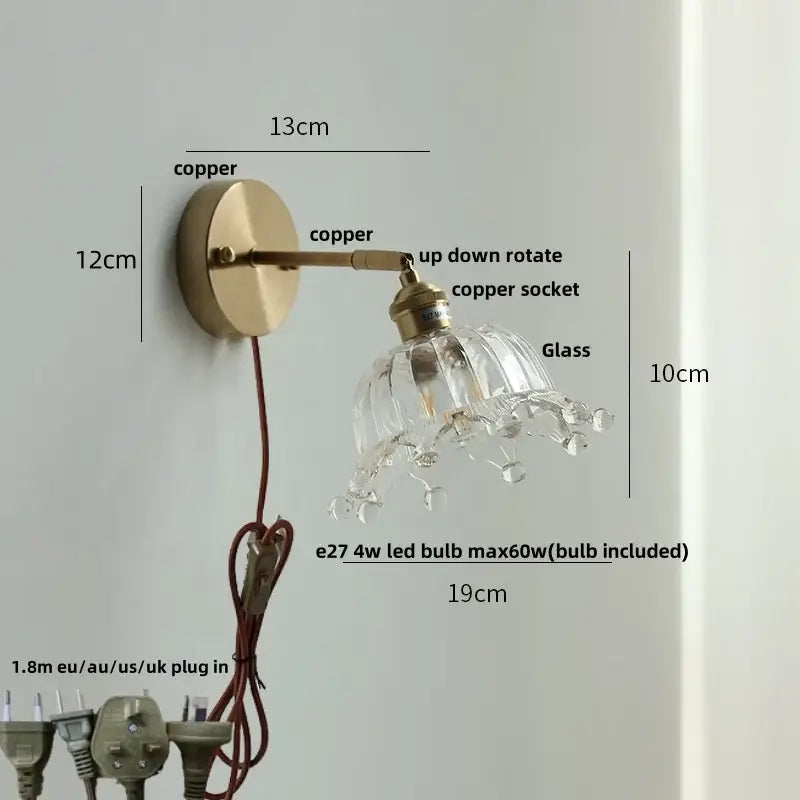 Brass wall lamp with decorbites clear flower glass shade and dangling crystal droplets for bedroom use