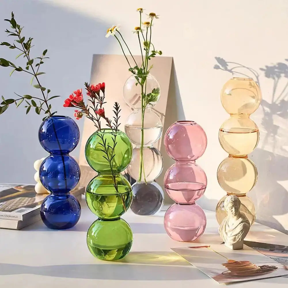 Colorful translucent glass bubble vases in blue green pink and amber hues for elegant home decor by decorbites