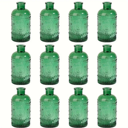 Set of twelve decorbites clear glass bud vases in emerald green with intricate embossed circular and beaded patterns
