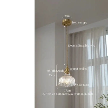 A delicate decorbites clear glass led pendant light with fluted design and brass accents for bedroom use