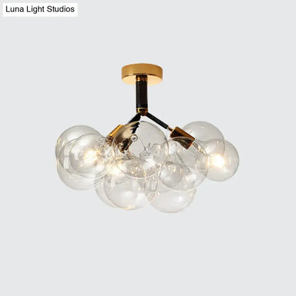 Modern glass bubble chandelier semi flush ceiling light with brass accents and black wiring for foyer illumination