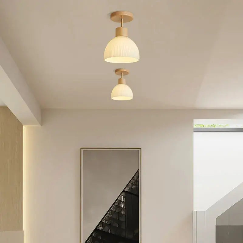 Two minimalist decorbites coco wood glass ceiling chandelier lights with cream ribbed glass shades and wood finish fixtures