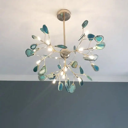 A decorbites colorful agate led bedroom pendant light featuring a gold-toned metal frame with turquoise agate slices