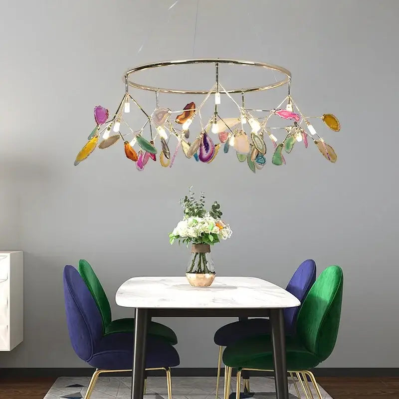 A modern decorbites colorful agate led leaf chandelier with circular brass frame and translucent agate slices for bedroom