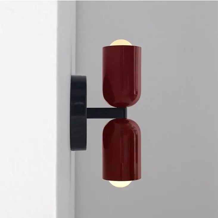 DecorBites modern wall sconce with dual glossy burgundy glass shades and sleek black mounting bracket for stylish lighting
