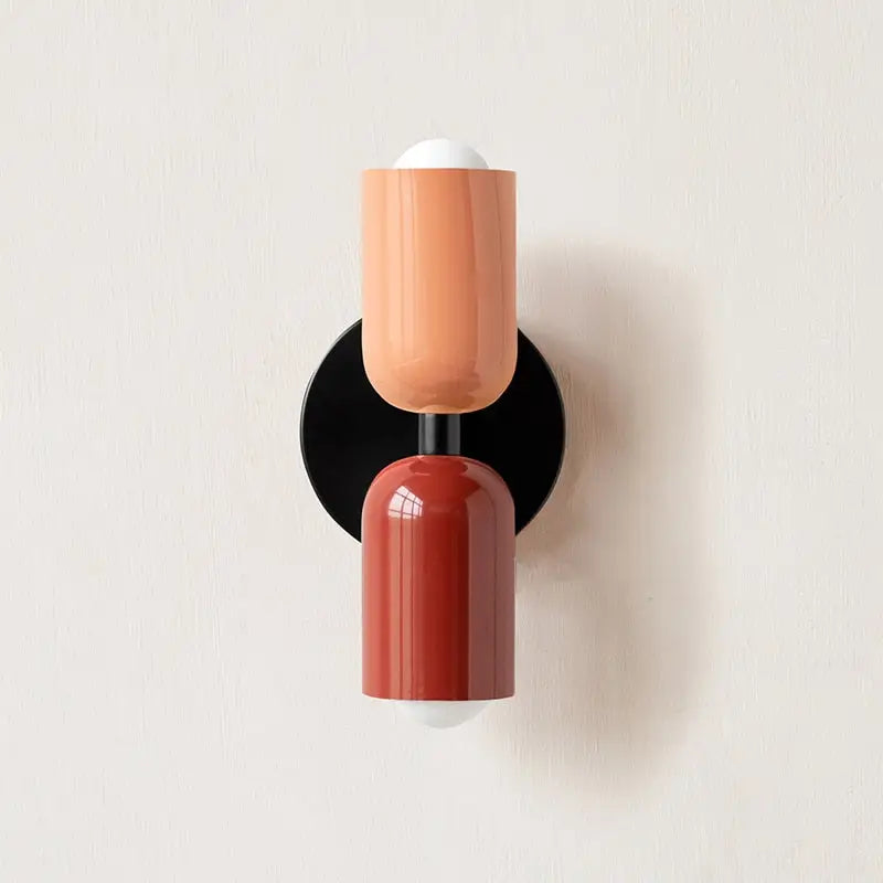 DecorBites™ colorful modern wall sconce with a two-toned glass shade in matte peach and glossy terracotta on black base