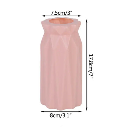 A sleek blush-pink ceramic modern flower vase with faceted geometric design and fluted rim for home décor