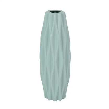 A tall slender light blue ceramic flower vase with textured ribbed surface and flared base by DecorBites™