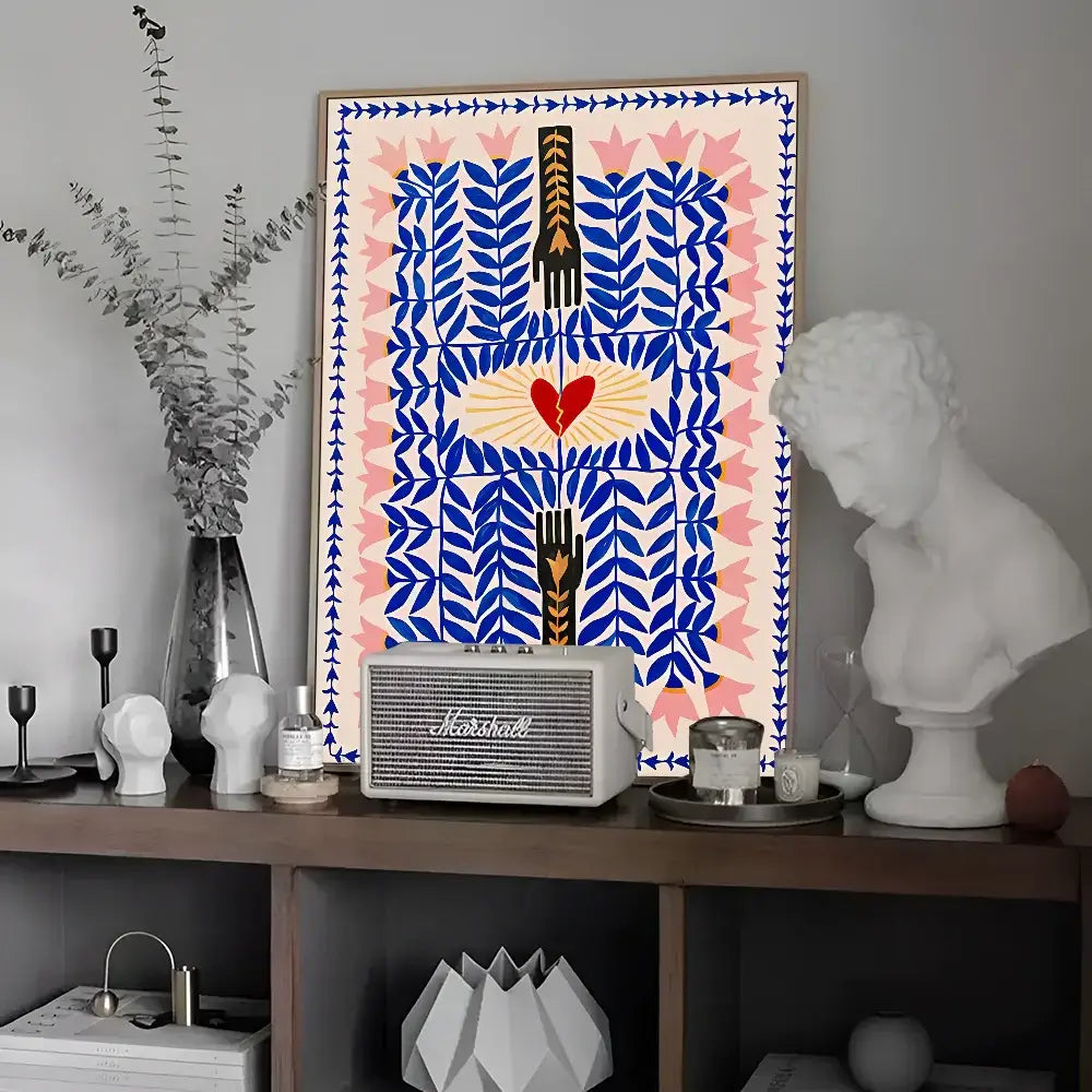 Framed wall art featuring a bold blue and pink geometric pattern with black hands holding a red heart in a leopard vintage poster design
