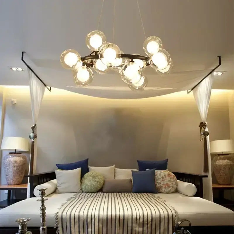 DecorBites contemporary black and gold chandelier with dark metal frame and multiple clear white glass ball bulbs