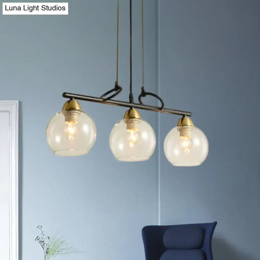 Modern three-light DecorBites™ black pendant chandelier with clear prismatic glass globes for dining hall lighting