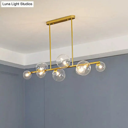 Gold-toned DecorBites™ contemporary ceiling light with clear glass globe bulbs for stylish dining room decor