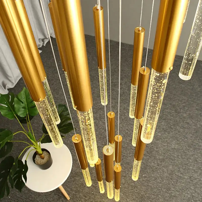Decorbites™ contemporary crystal chandelier with golden cylindrical pendant lights and glowing bubble-filled glass sections for large staircase