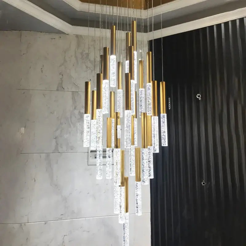 DecorBites contemporary crystal chandelier with gold-toned rods and crystal fixtures for large staircase lighting