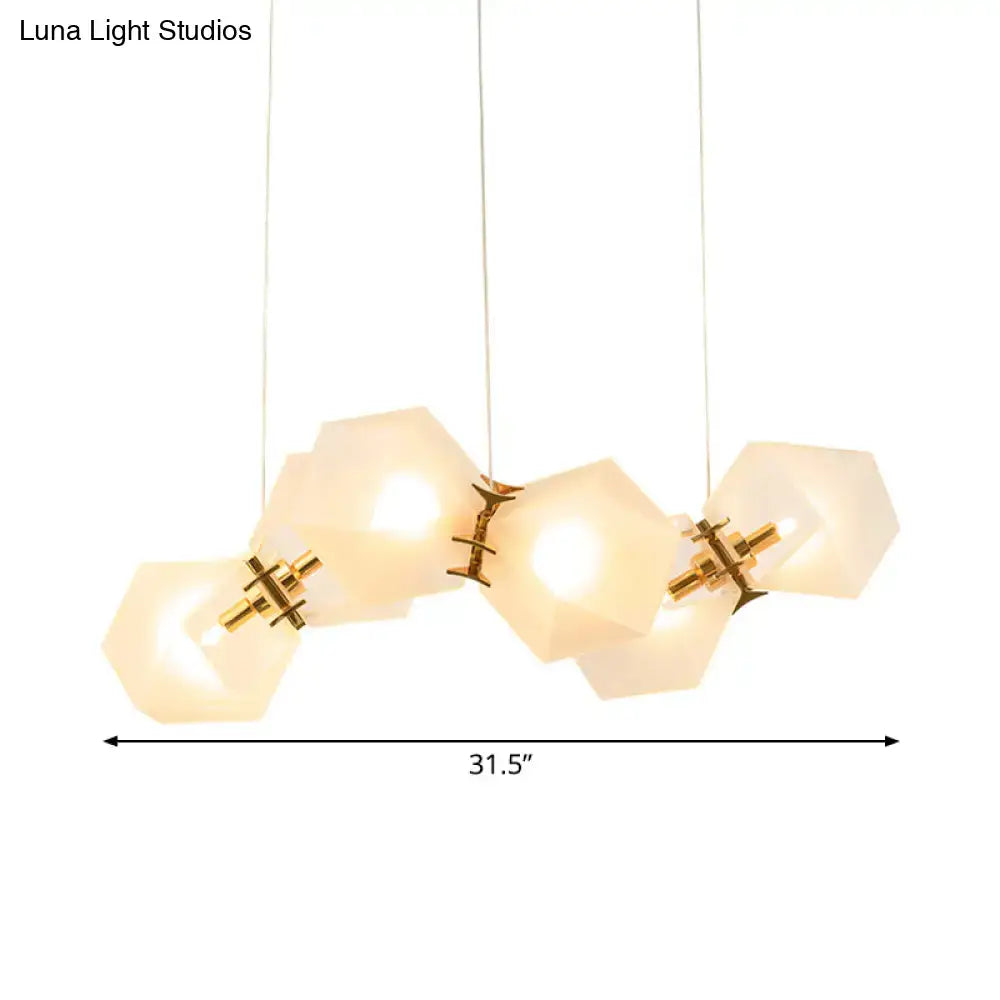 Modern hexagonal pendant honeycomb island lamp with frosted white glass shades and brass accents for living room use