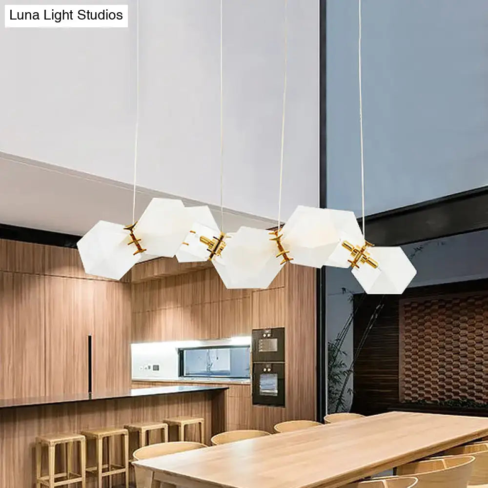Modern white hexagonal pendant light fixture with frosted white glass and gold-toned accents for glass honeycomb island lamp