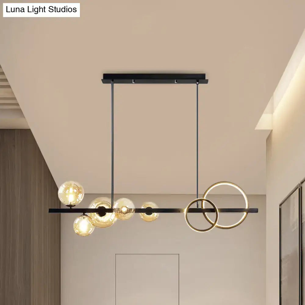 Decorbites contemporary 7-head island lamp with modern black and gold rings and smoke grey glass bulbs for dining room