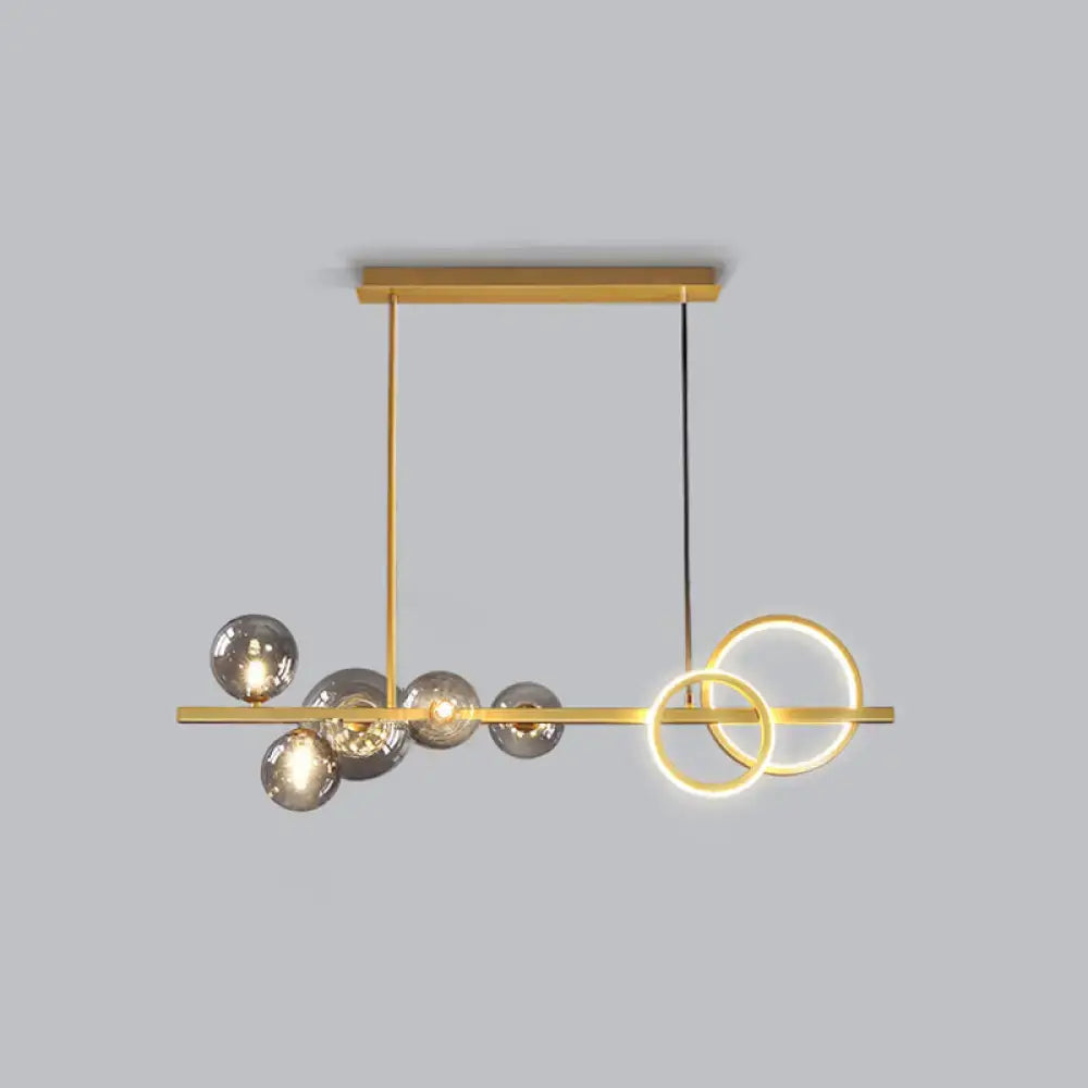 Decorbites contemporary glass island lamp with gold tones, milk white spheres, and smoke grey rings for dining room