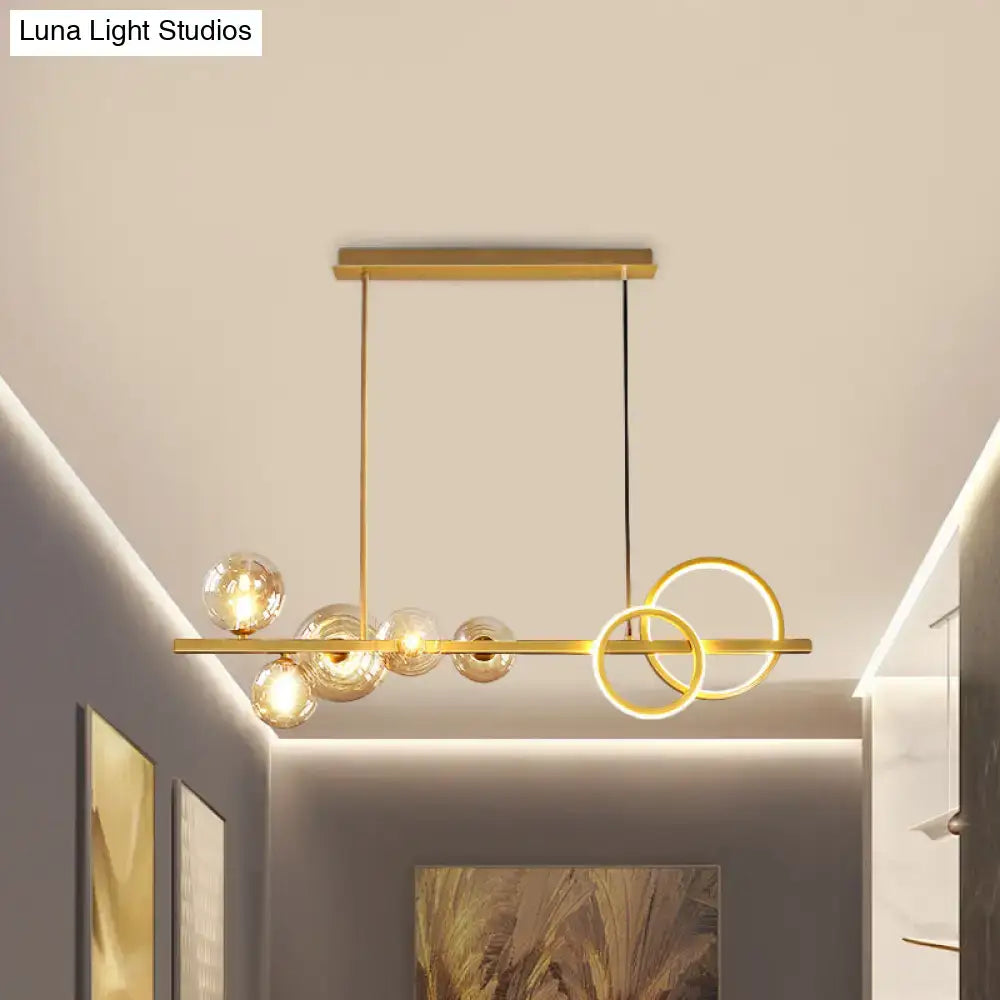 DecorBites contemporary gold-toned island lamp with hanging milk white glass globes and interlocking circular rings